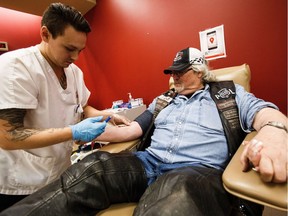 Ron Blackburn of the Canadian Lonewolves Independent Riders is set up by phlebotomist Harlee Courtepatte at the Edmonton Blood Donor Clinic on Saturday, June 4, 2016. The bikers donated blood to kick off a month-long campaign to recruit new donors.