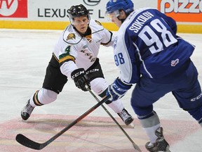Olli Juolevi #4 of the London Knights defends against Dimitry Sokolov #98 of the Sudbury Wolves.