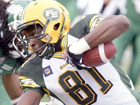 Edmonton's Devon Bailey lunges for yards during pre-season CFL action between the Saskatchewan Roughriders and the Edmonton Eskimos at Mosaic Stadium in Regina June 20, 2014.