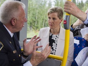 Regional Municipality of Wood Buffalo fire Chief Darby Allen, left, Her Royal Highness the Countess of Wessex, right, chat on a tour of Fort McMurray, visiting areas damaged by May's wildfire.