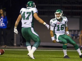 Saskatchewan Roughriders QB Brett Smith (16) celebrates his touchdown against the B.C. Lions with teammate FB Matthew Rea (47) during the second half of their CFL football game in Vancouver, British Columbia, July 10, 2015. REUTERS/Ben Nelms ORG XMIT: VAN20