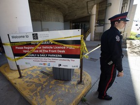 Police on scene at a suspicious death outside the Chateau Lacombe hotel parkade in downtown Edmonton on June 20, 2016.