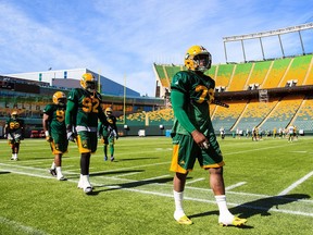 Team members walk along the sideline during Edmonton Eskimos training camp at Commonwealth Stadium in Edmonton on June 13, 2016.