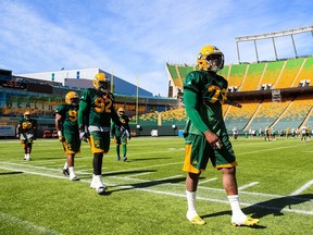 Team members walk along the sideline during Edmonton Eskimos training camp at Commonwealth Stadium in Edmonton, Alta., on June 13, 2016.  The field is now sponsored by the Brick, which prompted a column by Paula Simons and a response in Tuesday's letters from Eskimos president Len Rhodes.