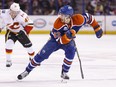 Edmonton's Jordan Oesterle (82) is chased by Calgary's Hunter Shinkaruk (49) during the second period of a NHL game between the Edmonton Oilers and the Calgary Flames at Rexall Place in Edmonton, Alta., on Saturday April 2, 2016. Photo by Ian Kucerak