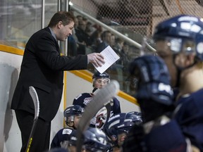 Head coach Jason McKee speaks with his players during an AJHL playoff game between the Spruce Grove Saints and the Sherwood Park Crusaders at the Arena Sports Centre in Sherwood Park, Alta., on Tuesday, March 17, 2015. Ian Kucerak/Postmedia Network