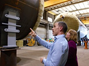 David Turner, president and GM of Cessco Fabrication and Engineering, shows Alberta Energy Minister Margaret McCuaig-Boyd pressure vessels the company is manufacturing after a news conference Monday, June 6, 2016.