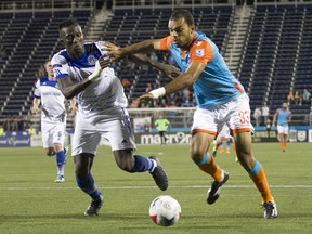 UPLOADED BY: Derek  FC Edmonton defender Papé Diakité battles for the ball with Miami FC striker Pablo Campos. Miami won 1-0.