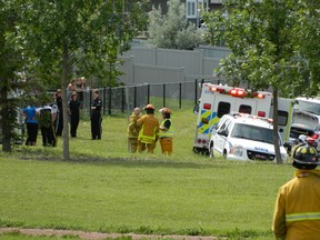 First responders at the scene of a call involving a two-year-old girl found in a man-made lake in Morinville, AB. The girl was pronounced dead. July 25, 2015.
