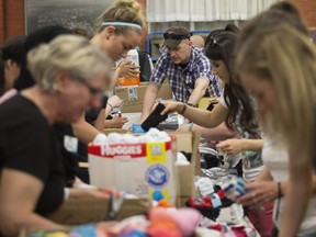 Volunteers sort donations for Fort McMurray wildfire evacuees at the Edmonton Emergency Relief Services,  on Wednesday May 4, 2016. Thousands of Edmontonians jumped to volunteer in the face of the fire.