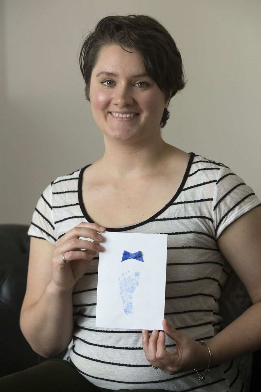 Jessica Demetrick holds a footprint of her birth son on June 23, 2016. It was one of several mementoes she kept of the child she gave up for adoption.