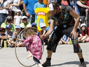 Uri Weiss with Cirque No Problem performs with his daughter during the 2016 Edmonton International Street Performers Festival at Churchill Square in Edmonton, on Tuesday, July 12, 2016. Ian Kucerak / Postmedia (Standalone) Standalone photo