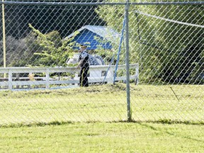 A Grande Prairie RCMP officer at the Bear Creek Pool enclosure on Tuesday July 12, 2016, after a four-year-old boy was found dead at the bottom of the closed city pool.