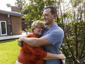 Kelly Mallard and her adopted son Brock hug at her home in Spruce Grove, on July 12, 2016.