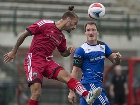 Albert Watson of FC Edmonton watches Ottawa's James Bailey head the ball during the Eddies' 1-0 victory at Clarke Park on Sunday, July 17, 2016.