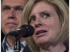 Alberta Premier Rachel Notley addresses the media as Yukon Premier Darrell Pasloski looks on during a meeting of Premiers in Whitehorse, Y.T., Friday, July 22, 2016.