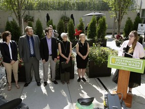 Alberta Labour Minister Christina Gray (right at podium) announced changes to the province's minimum wage rates at the Muttart Conservatory in Edmonton on June 30, 2016. Unifor president Jerry Dias says Alberta's move to a $15-per-hour mimimum wage by 2018 is good policy-making.
