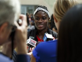 Edmonton runner Kendra Clarke speaks to the media at the introduction of the Olympic track team at City Hall on Monday. Clarke, Angela Whyte and Carline Muir are the three Edmonton track athletes going to Rio.