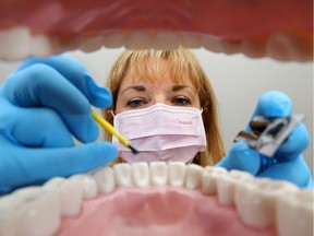 With some Albertans heading to British Columbia to save money on dental work, one writer suggests insurance companies push for lower dentist fees.