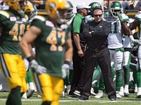 Saskatchewan Roughriders head coach Chris Jones watches as the Edmonton Eskimos line up during first half CFL pre-season action in Edmonton, Alta., on June 18, 2016. Chris who? The return of former head coach Chris Jones to Edmonton brings little reaction from the Eskimo players who say Jones, now with the Saskatchewan Roughriders, is a thing of the past.