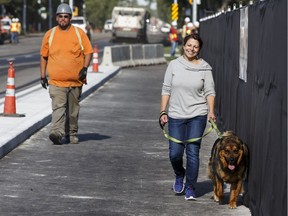 Camille Robertson crosses the 102 Avenue Bridge with her dog Bandit as it opens in Edmonton, on Friday, July 15, 2016.