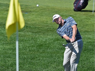 David Skinns of Suwanee, Ga., roped in by the cart path as he chips onto the 18th green is 9 under for the tournament during Round 2 of the Syncrude Oil Country Championship at the Glendale Golf & Country Club in Edmonton on July 29, 2016.