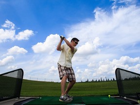 Dustin Perepelecta practices his swing at Mill Woods Golf Course in Edmonton, Alta., on Saturday, July 2, 2016. (Codie McLachlan/Postmedia)