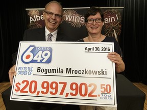 Alberta Gaming and Liquor Commission rresident Bill Robinson  presents a ceremonial cheque to Lotto 6/49 $21 million winner Bogumila Mroczkowski on Tuesday.