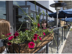 Diners on the patio at the Workshop Eatery in southeast Edmonton.