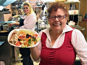 Alba Arevalo (right), one of the cooks at El Rancho Spanish Restaurant, is dishing out Latin dishes along with her daughter, restaurant owner Dora Arevalo (middle) during the Mi Tierra Festival.