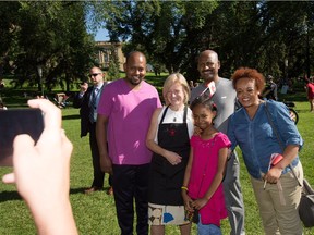 Premier Rachel Notley, centre, poses with a family during Canada Day festivities at the Alberta legislature in Edmonton July 1, 2016. From left is Anteneh Teshome, Notley, Asfaha Abate, his daughter Lucy Asfaha, 9, and Tizita Tekleyohannes. Both Teshome and Tekleyohannes are visiting from Ethiopia.