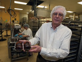 Jerry Bigam, owner of Kinnickinnick Foods, shows off gluten-free donuts.