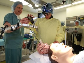 Dr. Keith Aronyk shows student Blaise Russell, 16, how to utilize brain surgery equipment in 2011 at Discovery Days in health sciences. Aboriginal high school students from across northern Alberta visited Edmonton for the event. Bigstone Cree Nation Chief Gordon T. Auger writes that training more indigenous people to serve their communities' health-care needs is one important step towards better aboriginal health.