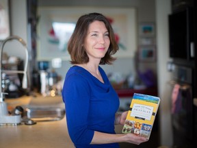 Jennifer Cockrall-King with her book, Food Artisans of the Okanagan, in her Edmonton home on March 30, 2016.
