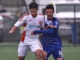 EDMONTON, ALTA: MAY 22, 2016 -- FC Edmonton Gustavo (20) battles with Carolina RailHawks Nazmi Albadawi during NASL at Clarke Field in Edmonton, May 22, 2016. (ED KAISER/PHOTOGRAPHER)