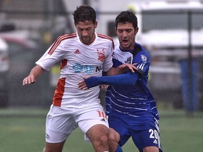 EDMONTON, ALTA: MAY 22, 2016 -- FC Edmonton Gustavo (20) battles with Carolina RailHawks Nazmi Albadawi during NASL at Clarke Field in Edmonton, May 22, 2016. (ED KAISER/PHOTOGRAPHER)