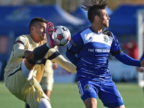 FC Edmonton Dustin Corea (6) turns away as Jacksonville Armada Shawn Nicklaw (15) gets his foot to head level going after the ball as they play their final game of the season in NASL action at Clarke Stadium in Edmonton, October 25, 2015.