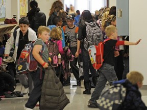 It is a mistake to divert precious education dollars form public schools into private options, write three parents in an op-ed. A 2012 file photo shows students leaving Major-General Griesbach School in north Edmonton in a year the Edmonton Public School district saw student numbers increase by 2,600.