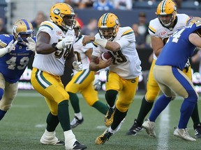 Edmonton Eskimos QB Mike Reilly scrambles during CFL action against the Winnipeg Blue Bombers in Winnipeg on Thu., July 14, 2016. Kevin King/Winnipeg Sun/Postmedia Network