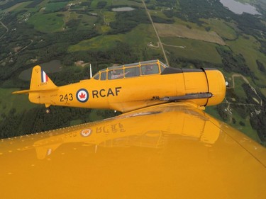 Yellow Thunder pilot David Watson (right) gives a ride to Edmonton Journal reporter Juris Graney in his Harvard airplane from Villeneuve Airport ahead of the Edmonton Air Show in Sturgeon County, on Thursday, July 21, 2016.