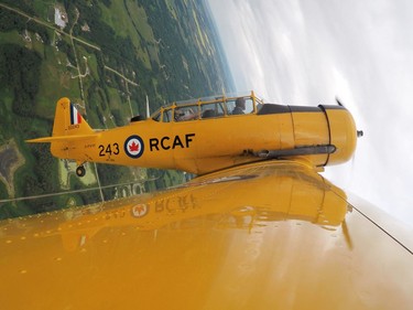 Yellow Thunder pilot David Watson (right) gives a ride to Edmonton Journal reporter Juris Graney in his Harvard airplane from Villeneuve Airport ahead of the Edmonton Air Show in Sturgeon County, on Thursday, July 21, 2016.