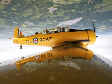 Yellow Thunder pilot David Watson (right) gives a ride to Edmonton Journal reporter Juris Graney in his Harvard airplane from Villeneuve Airport ahead of the Edmonton Air Show in Sturgeon County, on Thursday, July 21, 2016.