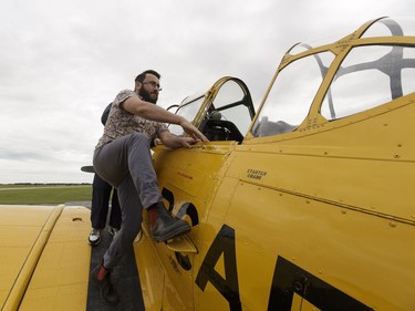 Yellow Thunder pilot David Watson gives a ride to Edmonton Journal reporter Juris Graney (centre) in his Harvard airplane from Villeneuve Airport ahead of the Edmonton Air Show in Sturgeon County, on Thursday, July 21, 2016.