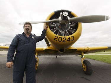 Yellow Thunder pilot David Watson poses for a photo with his Harvard airplane at Villeneuve Airport ahead of the Edmonton Air Show in Sturgeon County, on Thursday, July 21, 2016.