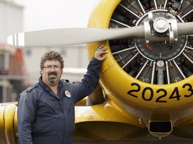 Yellow Thunder pilot David Watson poses for a photo with his Harvard airplane at Villeneuve Airport ahead of the Edmonton Air Show in Sturgeon County, on Thursday, July 21, 2016.