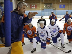 Edmonton Oilers head coach Todd McLellean (left) talks to the team's prospects at Edmonton Oilers orientation camp in Jasper, Alberta on Monday July 4, 2016.