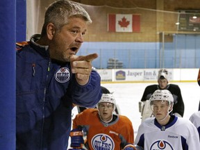 Edmonton Oilers head coach Todd McLellean (left) talks to the team's prospects at Edmonton Oilers orientation camp in Jasper, Alberta on Monday July 4, 2016.