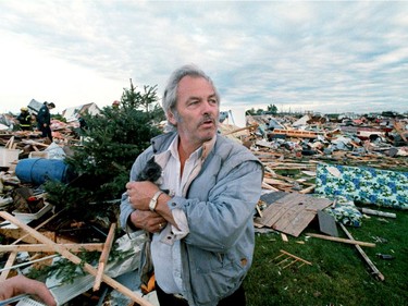 A shocked  Ken Bond cuddles a cat at the Evergreen Mobile Home Park.