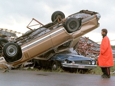 A police officer walks by some of the carnage on the southeast side of Edmonton after a massive tornado struck on Friday July 31, 1987.