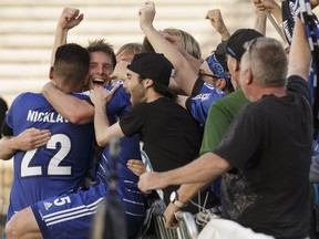 Edmonton's Daryl Fordyce (second from left) celebrates his game-winning goal with fans and players during NASL soccer play between FC Edmonton and the New York Cosmos at Clarke Stadium on Wednesday, July 27, 2016.